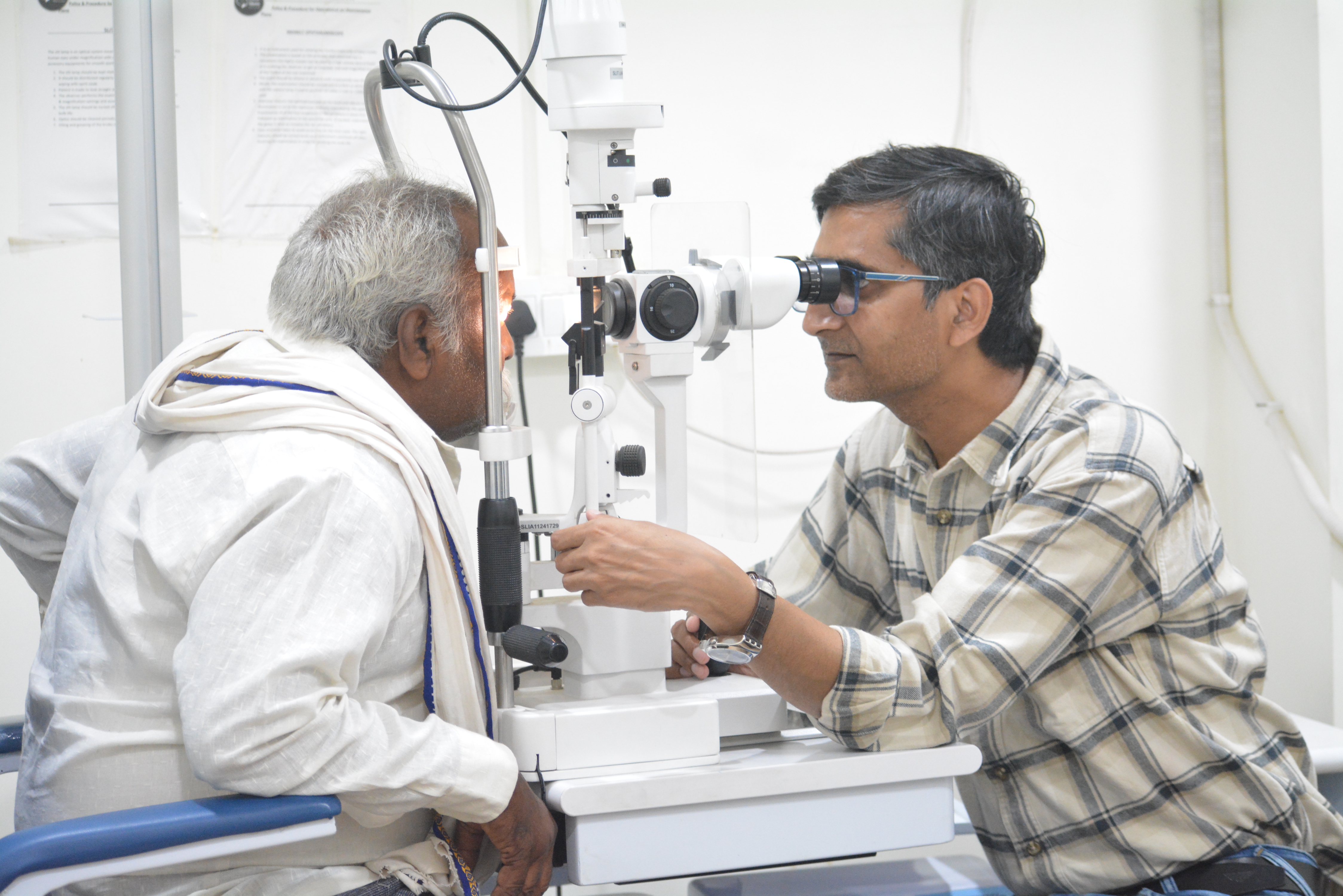 Eye specialist examining diabetic patient's retina using slit lamp at Indumati Netralaya, Prayagraj