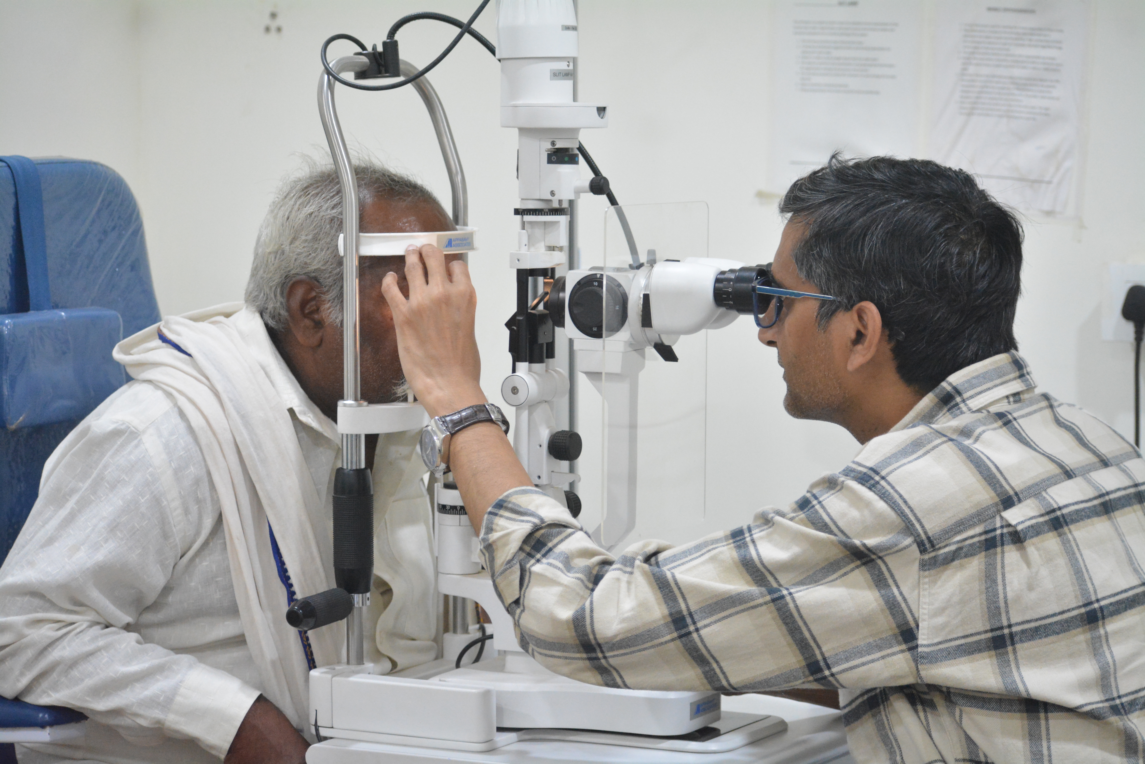 Senior ophthalmologist at slit lamp performing eye examination at Indumati Netralaya