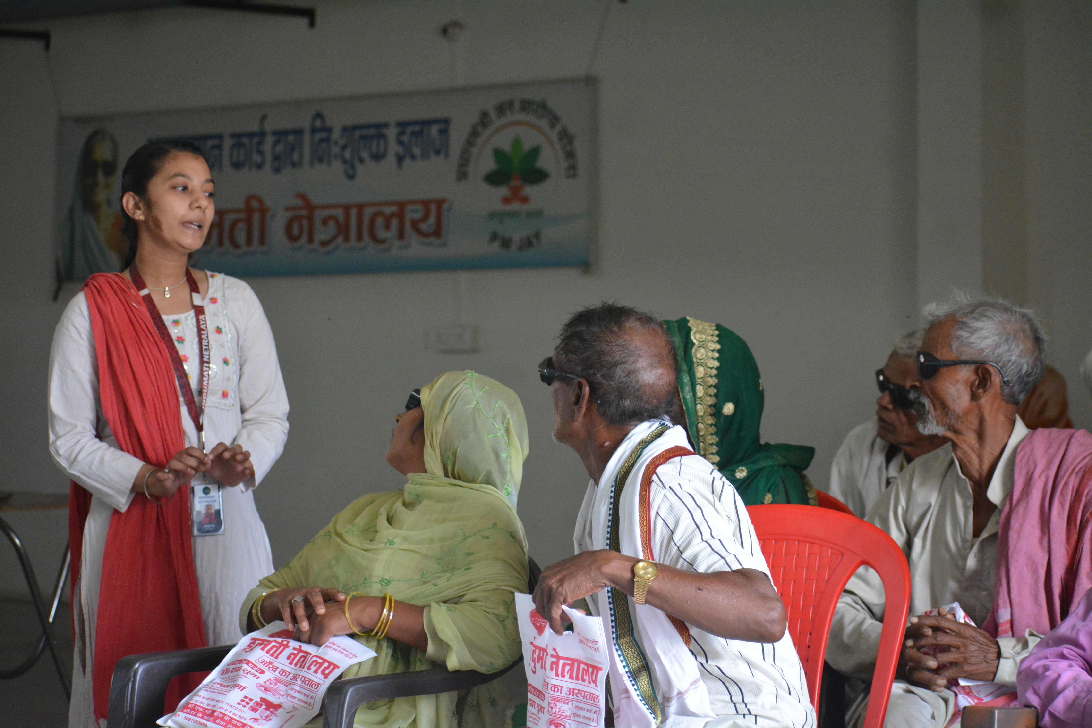 Indumati Netralaya staff conducting free eye camp patient counselling session in a rural village, Prayagraj