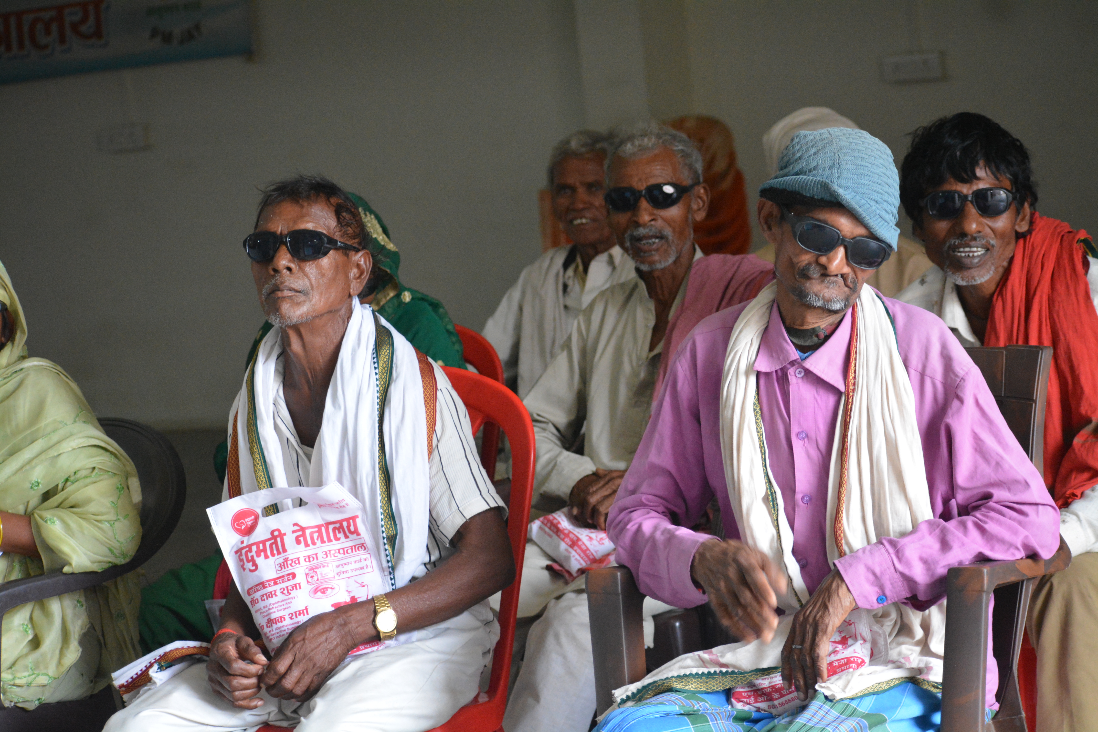 Rural patients post-surgery at Indumati Netralaya eye camp with Indumati Netralaya brochure